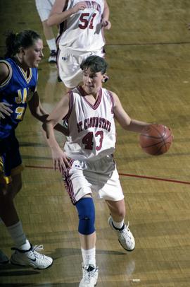 St. Cloud State women's basketball player Tina Schreiner dribbles the ball against South Dakota State University