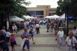 People gather on sidewalks to visit vendors' booths, Lemonade Concert and Art Fair, St. Cloud State University