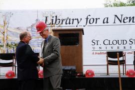 Arne Carlson and Bruce Grube shake hands, Miller Center, St. Cloud State University