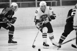 A St. Cloud State hockey player handles the puck, St. Cloud State University