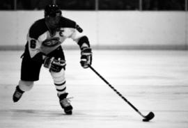 Hockey player Kelly Hultgren in a game against the University of Minnesota, St. Cloud State University