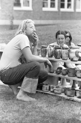 A man checks out merchandise, Lemonade Fair, St. Cloud State University