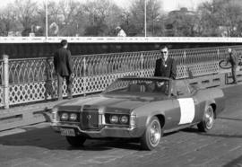 Charles Graham rides in the back of a car during a parade, St. Cloud State University