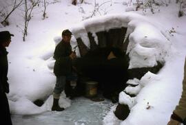 Harry Goehring at entrance to "bat sewer", St. Cloud State University