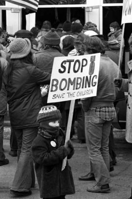 A child holds a sign during a Vietnam war protest