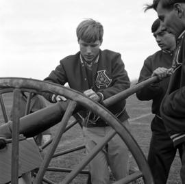 Cannon being loaded at a homecoming football game, St. Cloud State University