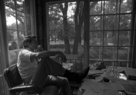 Richard Kisch sits in the Alumni House (1973), St. Cloud State University