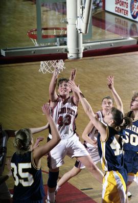 St. Cloud State women's basketball player Tina Schreiner drives to the basket against Augustana College