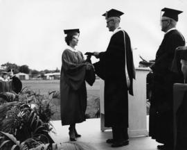 Woman receives a degree at commencement, Selke Field (1937), St. Cloud State University