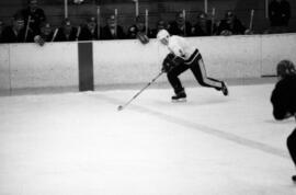 St. Cloud State hockey player Bob Motzko moves the puck during a men's hockey game against the University of Wisconsin-River Falls