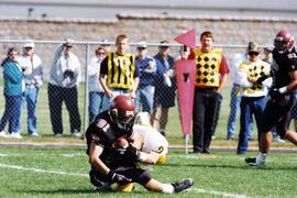 Mike McKinney is tackled during a football game, St. Cloud State University