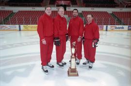 Coach Craig Dahl and other coaches with the Broadmoor playoff tournament trophy, St. Cloud State University