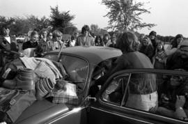 Students try to get as many people into a VW Bug car during homecoming, St. Cloud State University