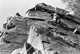 Man climbs up a cliff at the Taylors Falls State Park, St. Cloud State University